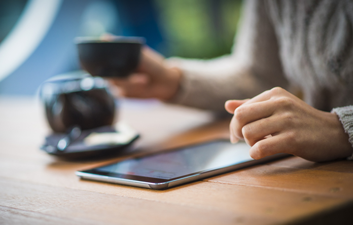 Woman Using Digital Tablet in a Cafe