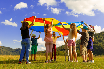 Children playing with a large kite